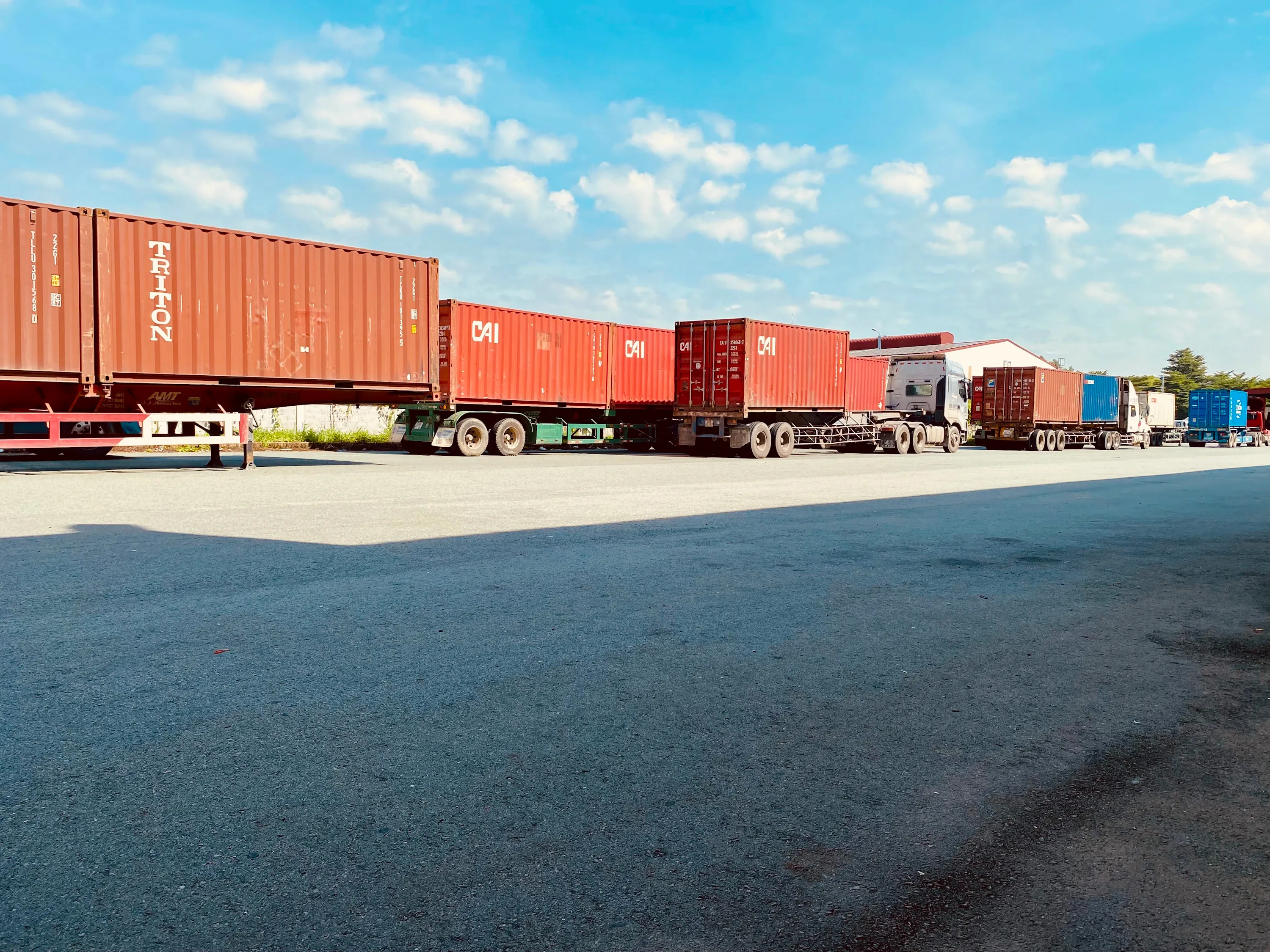 Row of shipping containers on chassis in a truck yard