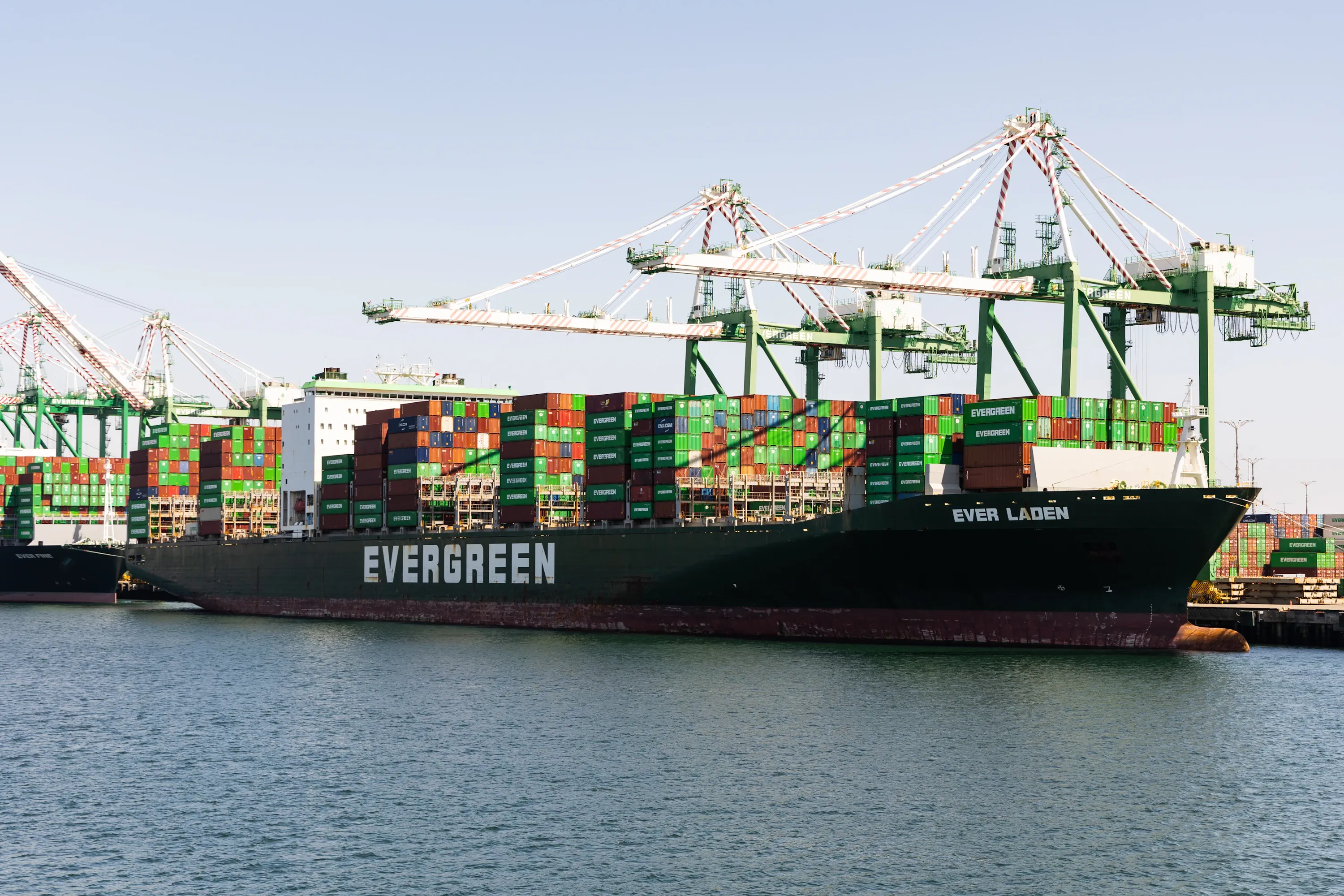 Container ship at a US port under loading cranes
