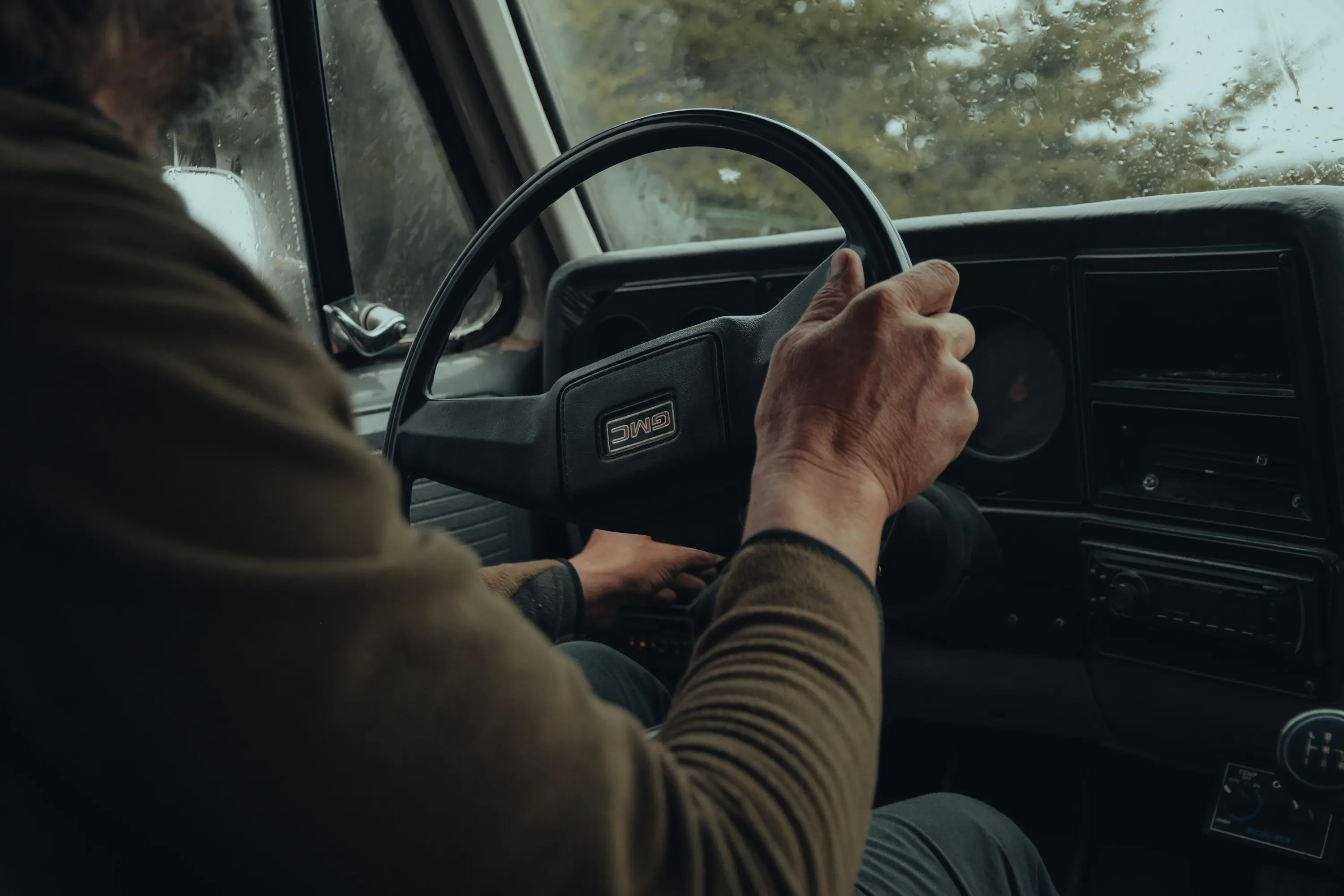 Truck driver with hands on the steering wheel